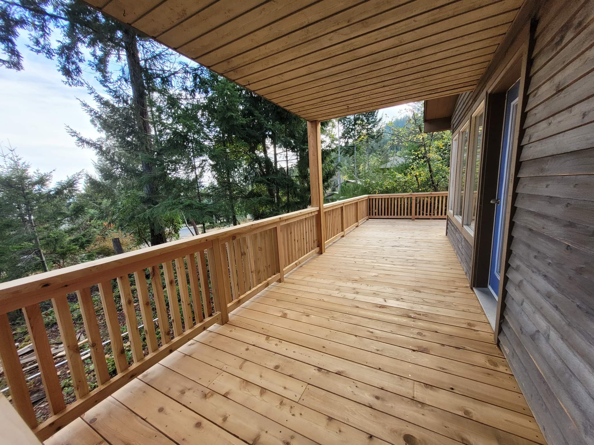 Saanich Peninsula — completed covered cedar deck and balcony repair, clean finish with new decking and railings