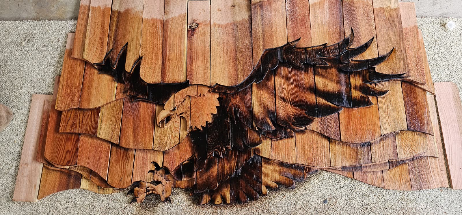Salt Spring Island project — custom eagle motif feature panel, flat cedar, pre-installation detail