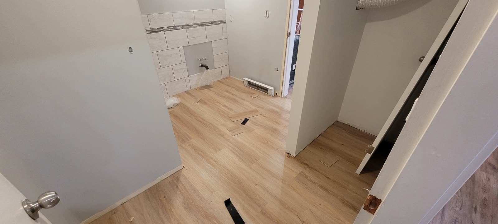 Basement suite renovation with light LVP flooring — Dallas Rd, Sooke