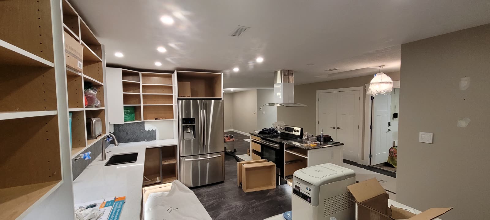 Dark charcoal LVP flooring throughout open-concept main floor — View Royal renovation