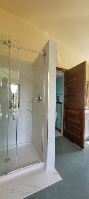 Bathroom renovation — tub surround with subway tile, hex floor tile · Salt Spring Island