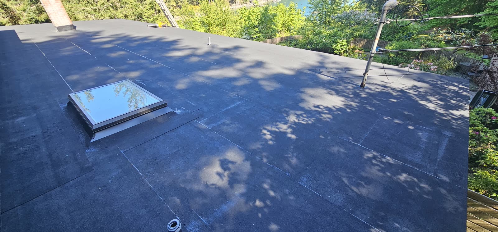 Salt Spring Island project — completed 2-ply torch-on SBS flat roof with skylight installation, Salt Spring Island