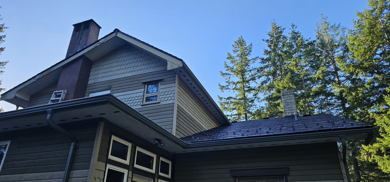 South Nanaimo — EnviroSlate tile close-up at chimney, clear blue sky