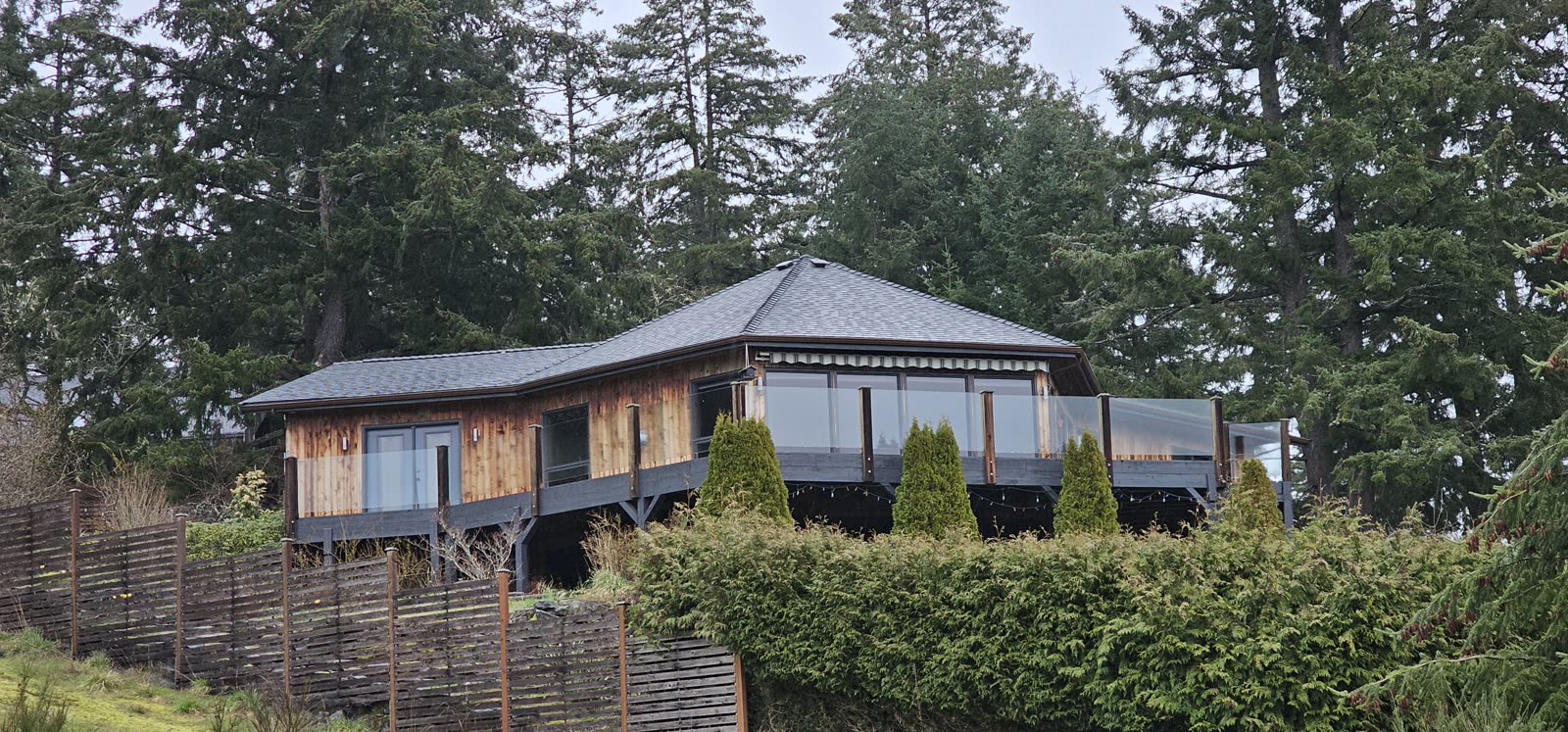 Salt Spring Island project — completed dark charcoal asphalt shingle reroof, full house exterior