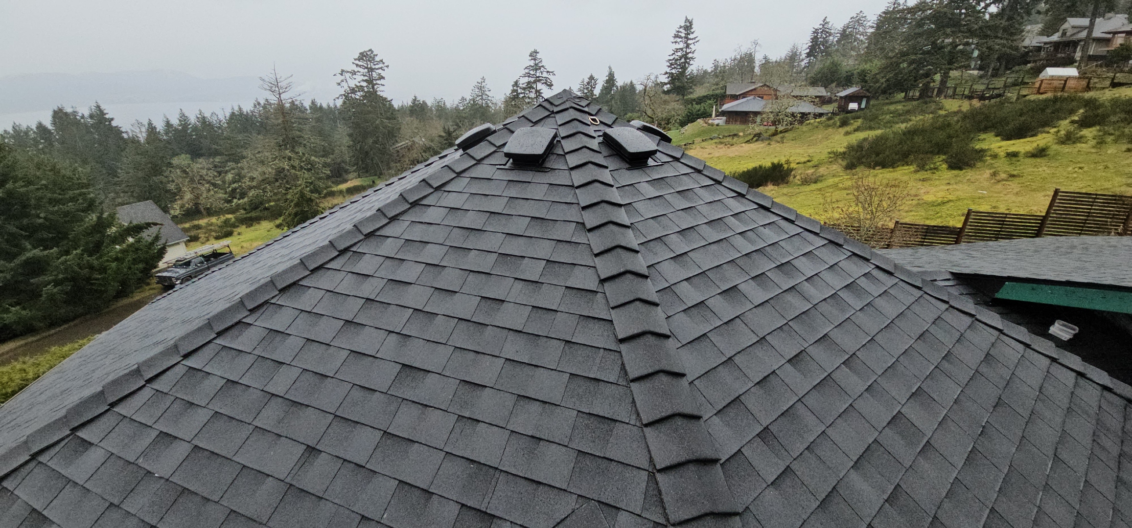 Salt Spring Island roofing — hip and ridge intersection, complex geometry, Gulf Islands backdrop